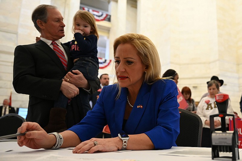 Leslie Rutledge, right, files her candidacy for Lt. Governor  as her husband, Boyce Johnson, and her daughter, Julianna Carol Johnson, 2, stand with her in the Arkansas State Capitol on Monday, Feb. 28, 2022.

(Arkansas Democrat-Gazette/Stephen Swofford)