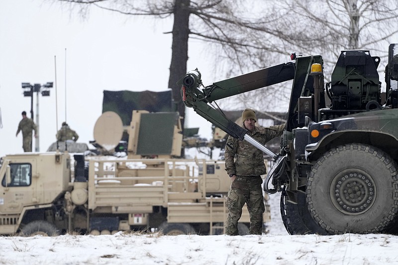 US soldiers with military vehicles gather at a local airport in Arlamow, southeastern Poland, near the border with Ukraine, on Monday, Feb. 28, 2022. President Vladimir Putin dramatically escalated East-West tensions by ordering Russian nuclear forces put on high alert following new crippling Western sanctions that forced his Central Bank to sharply raise its key rate Monday to save the ruble from collapse. (AP Photo/Czarek Sokolowski)