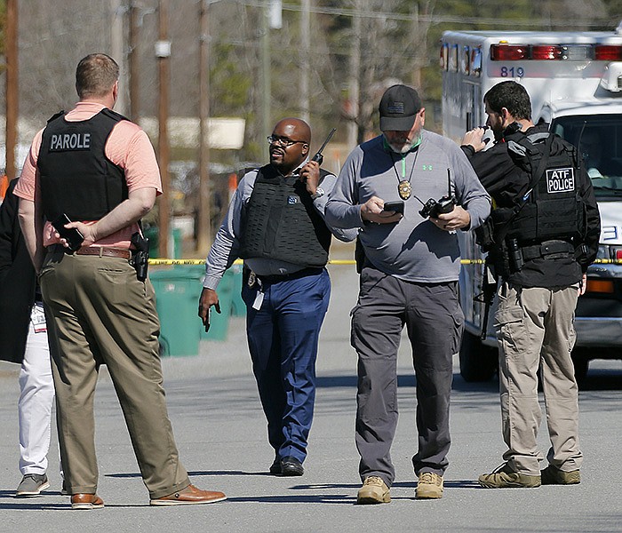 Solomon Graves (left center), Department of Corrections Secretary, listens to a radio as police from multiple agencies search for an armed man who allegedly shot and killed an Arkansas Department of Corrections officer on Monday, Feb. 28, 2022, near Maumelle. 
(Arkansas Democrat-Gazette/Thomas Metthe)