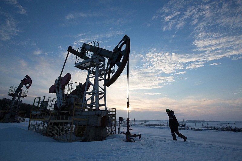 An oil worker inspects a pumping jack, also known as a 'nodding donkey,' during drilling operations in an oilfield operated by Bashneft in the village of Otrada, 150 kilomters from Ufa, Russia, on March 5, 2016. MUST CREDIT: Bloomberg photo by Andrey Rudakov.