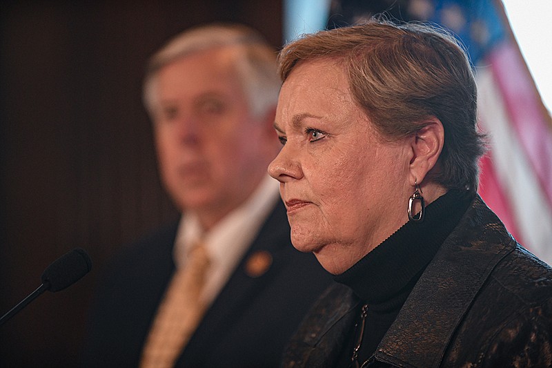 Gov. Mike Parson stands in the background as Paula Nickelson addresses the media Tuesday after being named as acting director of the Missouri Division of Health and Senior Services by Parson during a press conference in his office at the Missouri state Capitol in Jefferson City. Nickelson, of Fulton, has worked with emergent issues in her 22 years with DHSS. (Julie Smith/For the FULTON SUN)