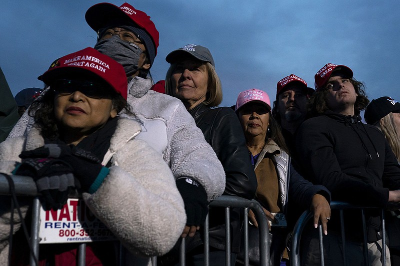 Supporters listen as speakers talk about the 2022 election prior to an appearance by former President Donald Trump at a rally on Saturday, Jan. 15, 2022, in Florence, Az. (AP Photo/Nathan Howard)
