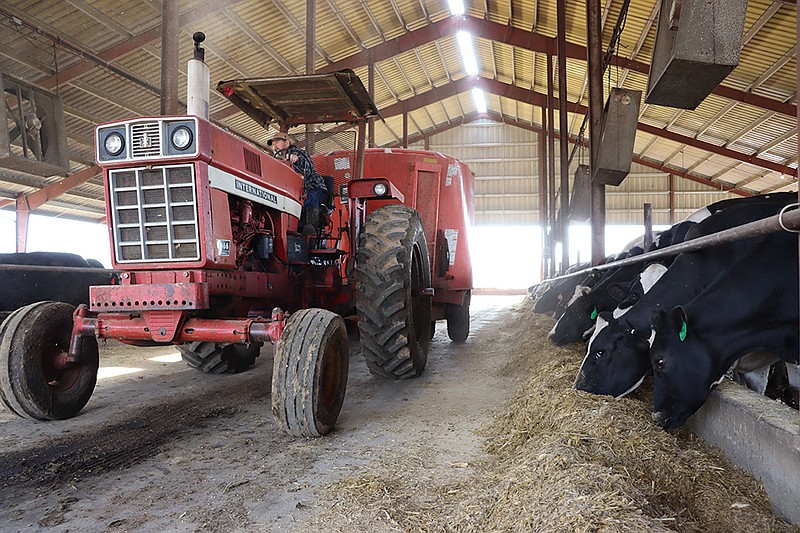 Bruemmer Dairy, which is operated by Ted Bruemmer and his father, Roger, shown driving a tractor, milks about 150 cows and has 150-200 acres of row crop. (Layne Stracener/For the FULTON SUN)