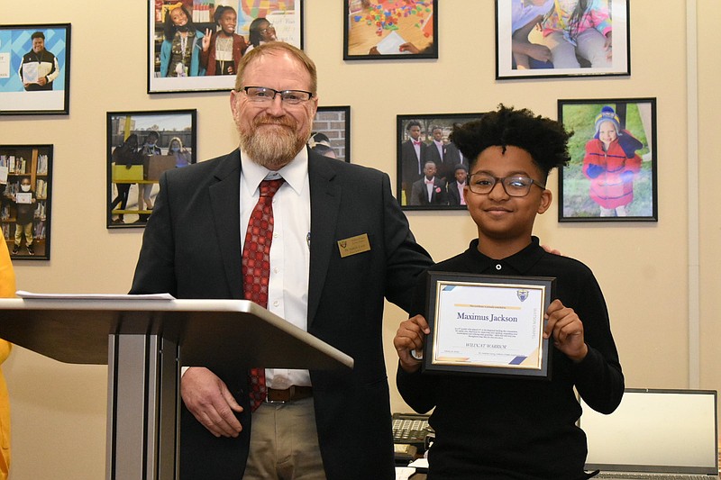 Watson Chapel School District Superintendent Andrew Curry awards sixth-grader Maximus Jackson with a Wildcat Warrior honor for placing second in the regional Spelling Bee. (Pine Bluff Commercial/I.C. Murrell)