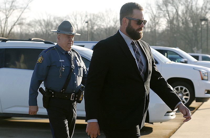 Arkansas State Troopers escort former former Lonoke County sheriff's deputy Michael Davis to the Cabot Readiness Center on Wednesday, March 16, 2022, in Cabot for the second day of Davis's trial. Davis is being tried for the killing of Hunter Brittain during a traffic stop last year.  
(Arkansas Democrat-Gazette/Thomas Metthe)