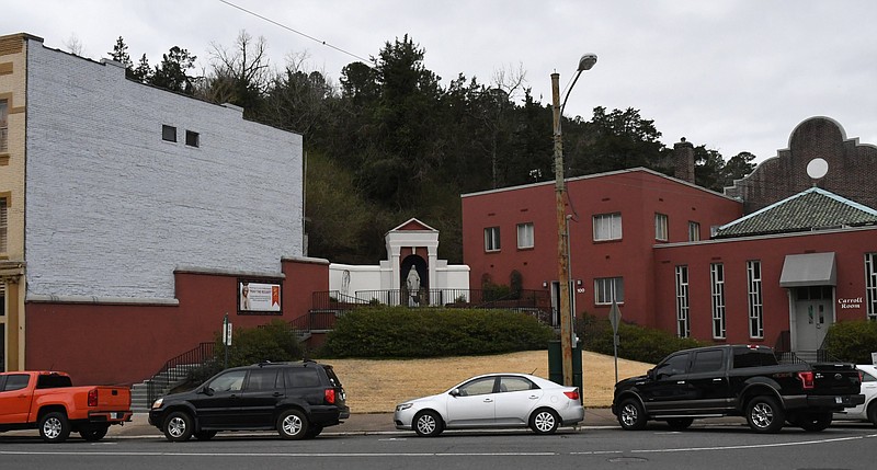 The owner of the Kollective Coffee + Tea’s building plans to have a mural painted on their exterior wall, left, but St. Mary of the Springs Catholic Church, right, has raised issues with the color scheme of the proposed artwork.