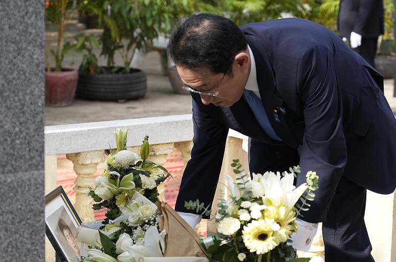 Japan's Prime Minister Fumio Kishida lays flowers at the memorial of late Police Superintendent Haruyuki Takata in Taing Krasaing Pagoda near Phnom Penh International Airport, in Phnom Penh, Cambodia, Sunday, March 20, 2022. Japanese Prime Minister Fumio Kishida was in Cambodia for talks with his counterpart, Hun Sen, on Sunday to deepen relations with one of the Southeast Asia's closest partners of both China and Japan. (AP Photo/Heng Sinith)