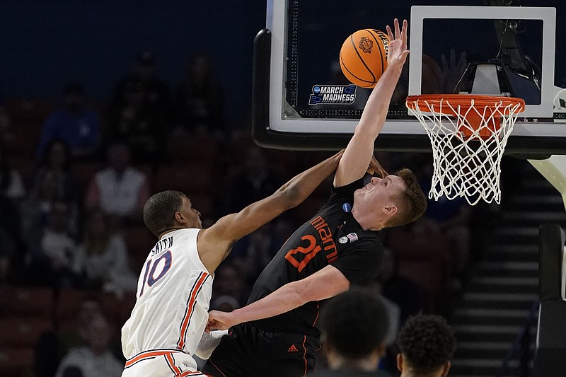 Miami's Sam Waardenburg (21) blocks Auburn's Jabari Smith (10) during the second half of a college basketball game in the second round of the NCAA tournament Sunday, March 20, 2022, in Greenville, S.C. (AP Photo/Brynn Anderson)