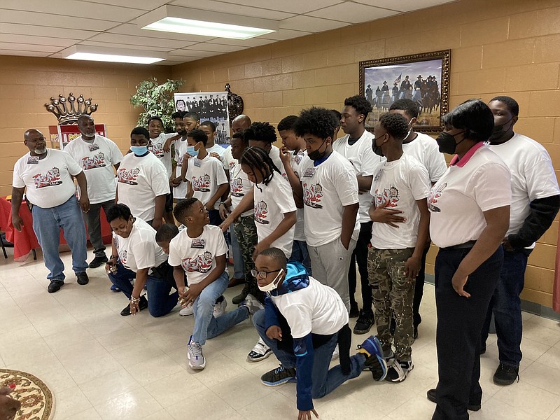 Participants in the weeklong Real Talk program take their positions for a group photo on Tuesday. The young men are listening to a series of speakers talk about making good choices in their lives. (Pine Bluff Commercial/Byron Tate)