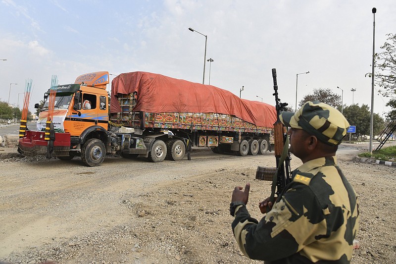 FILE - An Indian Border Security Force soldier guards as a truck carrying wheat from India moves to pass through the Attari-Wagah border between India and Pakistan, near Amritsar, India, late last month.Tuesday, Feb. 22, 2022. India?s foreign ministry says it has sent off tons of wheat to Afghanistan to help relieve desperate food shortages, after New Delhi struck a deal with neighboring rival Pakistan to allow the shipments across the shared border. (AP Photo/Prabhjot Gill, File)

(File Photo/AP/Prabhjot Gill)