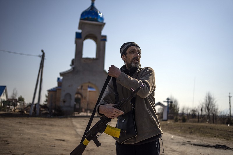 A member of the Ukraine territorial defense unit prepares to go to the front line in Yasnogorodk, on the outskirts of Kyiv, Ukraine, Friday, March 25, 2022. (AP Photo/ (AP Photo/Rodrigo Abd)