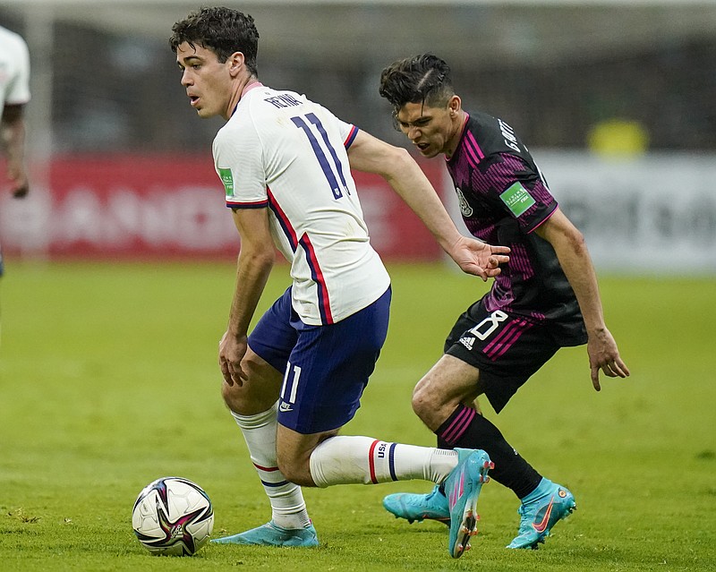 United States' Giovanni Reyna, left, dribbles the ball chased by Mexico's Gerardo Arteaga during a qualifying soccer match for the FIFA World Cup Qatar 2022 at Azteca stadium in Mexico City, Thursday, March 24, 2022. (AP Photo/Eduardo Verdugo)