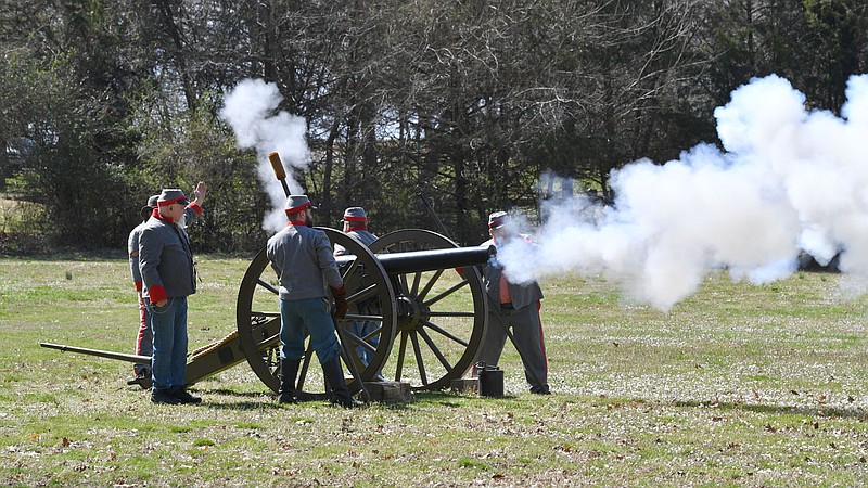 One of several groups of volunteers fires a Parrott rifle Friday, March 25, 2022, during the second day of training for volunteers at Prairie Grove Battlefield State Park. Volunteers learned about safe and historically accurate methods for demonstrating firearms and cannons ahead of the the coming season when such demonstrations take part at the park. 
(NWA Democrat-Gazette/Andy Shupe)