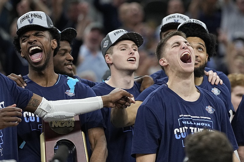 Villanova guard Collin Gillespie, right, celebrates after their win against Houston during a college basketball game in the Elite Eight round of the NCAA tournament on Saturday, March 26, 2022, in San Antonio. (AP Photo/David J. Phillip)