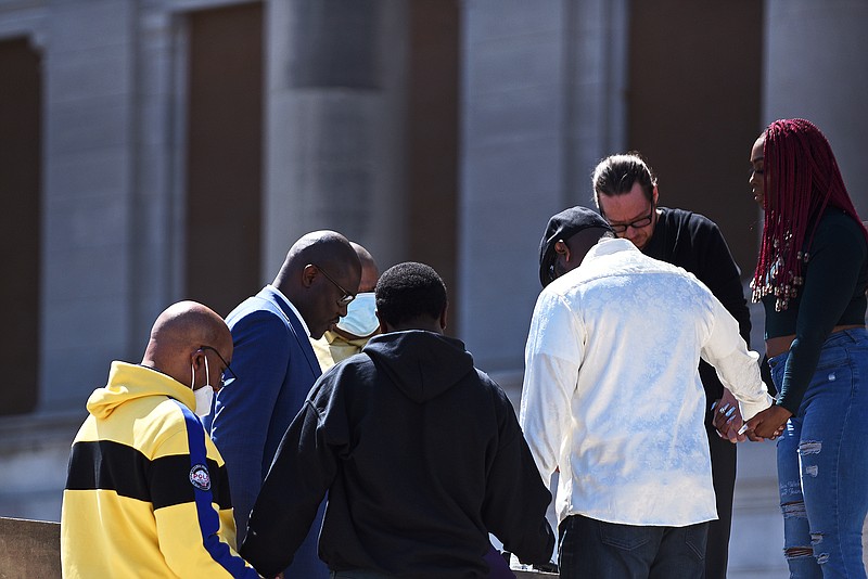 Mayor Frank Scott Jr. (second from left) prays with attendants of the Thousand Man Meeting “Us vs. Us" on Sunday at the State Capitol in Little Rock. NFL player Reggie Swinton spearheaded the event with hopes of eliminating the ongoing struggle of violence in the city. See more photos at arkansasonline.com/328rally/.
(Arkansas Democrat-Gazette/Staci Vandagriff)