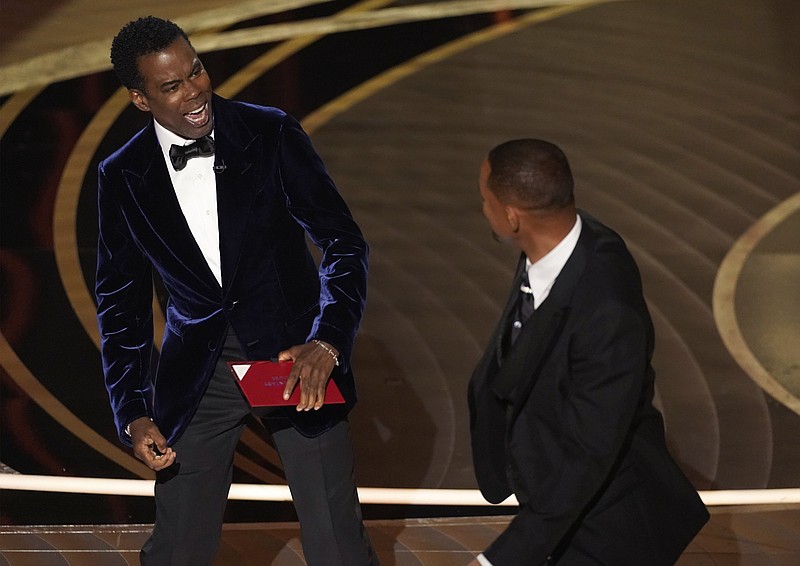 Presenter Chris Rock reacts after being hit on stage by Will Smith while presenting the award for best documentary feature at the Oscars on March 27 at the Dolby Theatre in Los Angeles. (AP/Chris Pizzello)