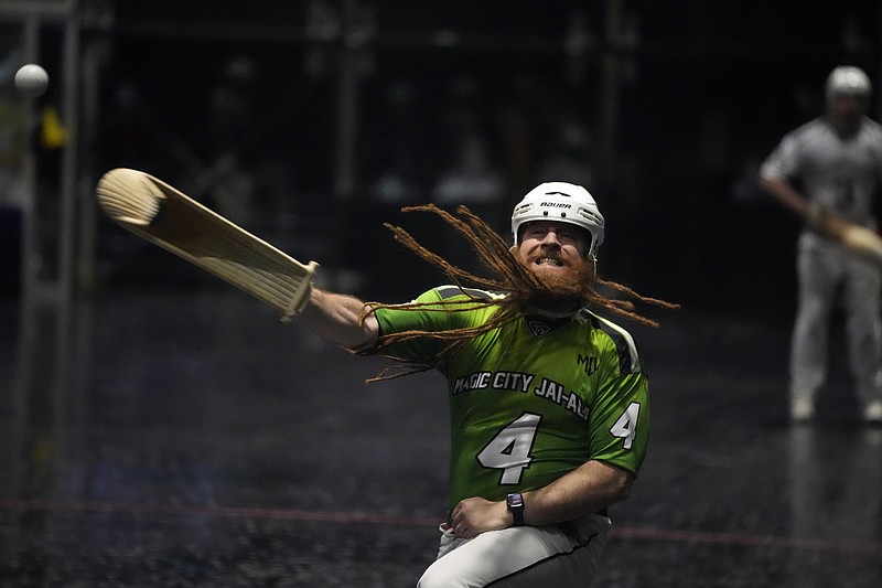 Dennis Dalton, known by the moniker "El Barba," Spanish for "The Beard," competes in a doubles Jai Alai match in the fronton at Magic City Casino, Sunday, March 13, 2022, in Miami. What could be Jai Alai's last stand is taking place at Magic City Casino, where a small group of committed enthusiasts are doing all they can to save the game that originated in the Basque region of Spain and France but took root in Miami during the go-go days of of the 1970s and 1980s. (AP Photo/Rebecca Blackwell)