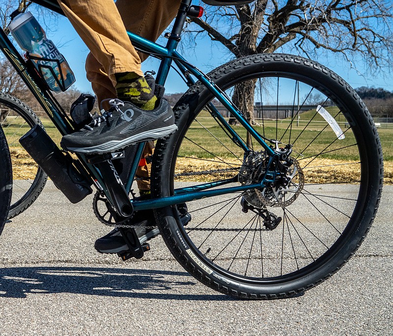 A cyclist pedals a bike during the first community bike ride of the season Saturday, March 26, 2022, at the North Jefferson Recreation Area. (Ethan Weston/News Tribune photo)