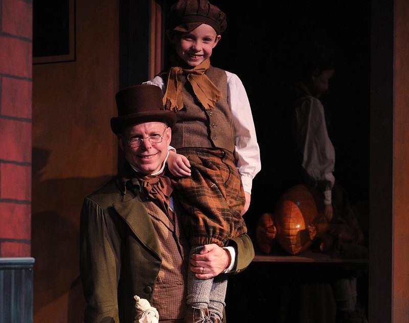 Ben Grimes played Bob Cratchit (with John Barham as Tiny Tim) in the Argenta Community Theater's 2018 production of "A Christmas Carol." (Democrat-Gazette file photo/Warren McCullough)