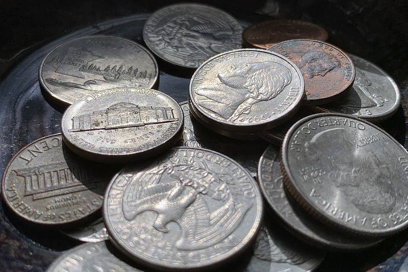 Quarters, nickels, dimes and pennies are held a bowl Thursday, March 31, 2022, in Tigard, Ore. Retailers, laundromats and other businesses that rely on coins want Americans to empty their piggy banks and look under couch cushions for extra change and “get coin moving.” A group of trade associations that represent individual businesses including banks, retail outlets, truck stops, grocery stores and more is asking the Treasury Department for more help convincing Americans to get coins back in circulation. (AP Photo/Jenny Kane)