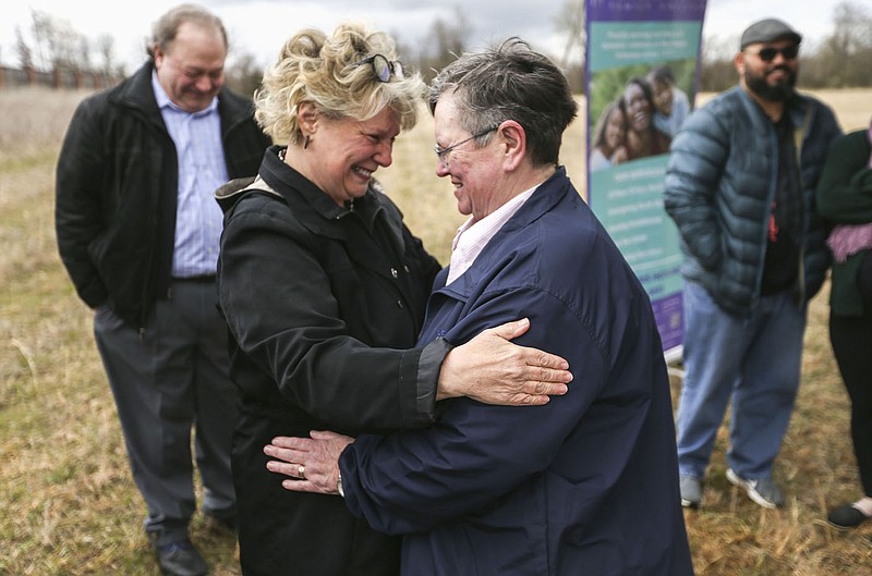 State Rep. Denise Garner (from left) embraces Teddy Cardwell, wife of the late Candy Clark, Thursday, March 31, 2022 at the site of what will be the new Candy Clark Pet Sanctuary behind the Peace at Home Family Shelter in Fayetteville. The space for animals, named after the late Candy Clark who served on the Washington County Quorum Court and helped found the Animal League of Washington County, will allow survivors of domestic abuse live with their pets on the site. Check out nwaonline.com/220401Daily/ and nwadg.com/photos for a photo gallery.

(NWA Democrat-Gazette/Charlie Kaijo)