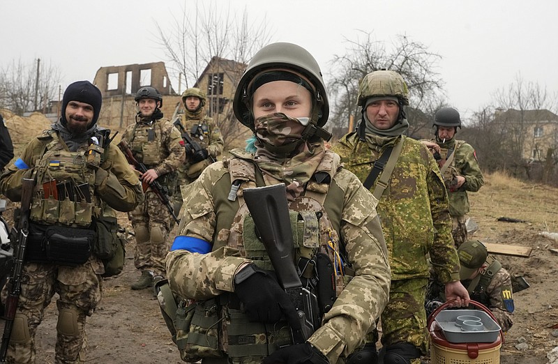 Ukrainian soldiers smile as they have a rest in Irpin close to Kyiv Friday, April 1, 2022. The more than month-old war has killed thousands and driven more than 10 million Ukrainians from their homes including almost 4 million from their country. (AP Photo/Efrem Lukatsky)