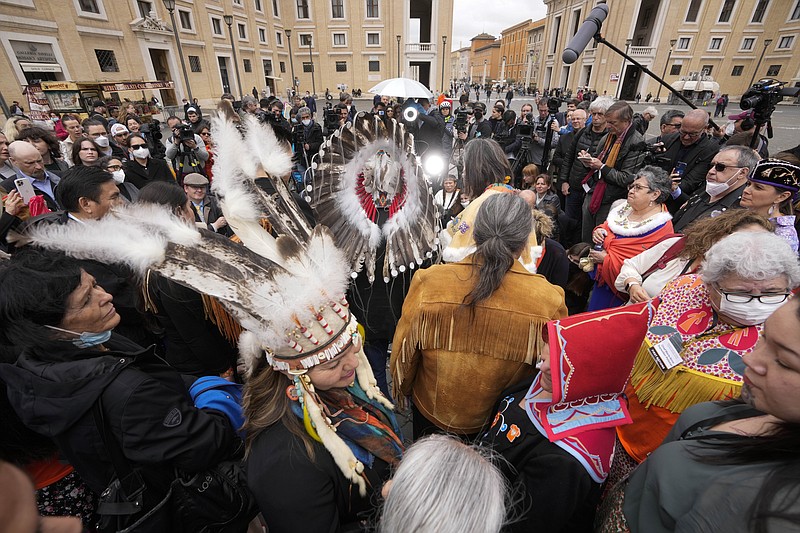 Members of a delegations by the Assembly of First Nations meet the journalists outside St. Peter's Square at the end of a meeting with Pope Francis at the Vatican, Thursday, March 31, 2022. (AP Photo/Andrew Medichini)