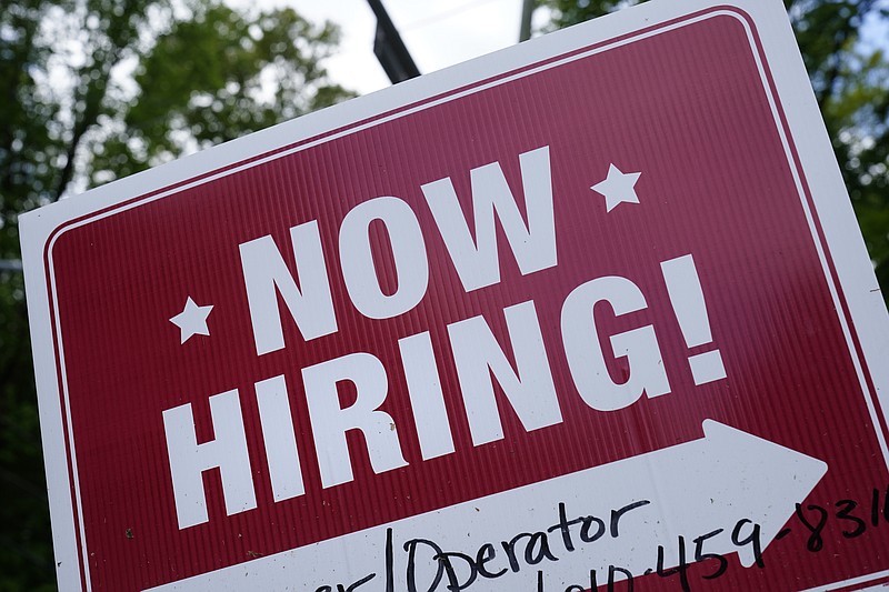 A "now hiring" sign is posted in Garnet Valley, Pa., Monday, May 10, 2021.  Job openings stayed at a near-record level in February, 2022, little changed from the previous month, continuing a trend that Federal Reserve officials see as a driver of inflation.    (AP Photo/Matt Rourke, File )
