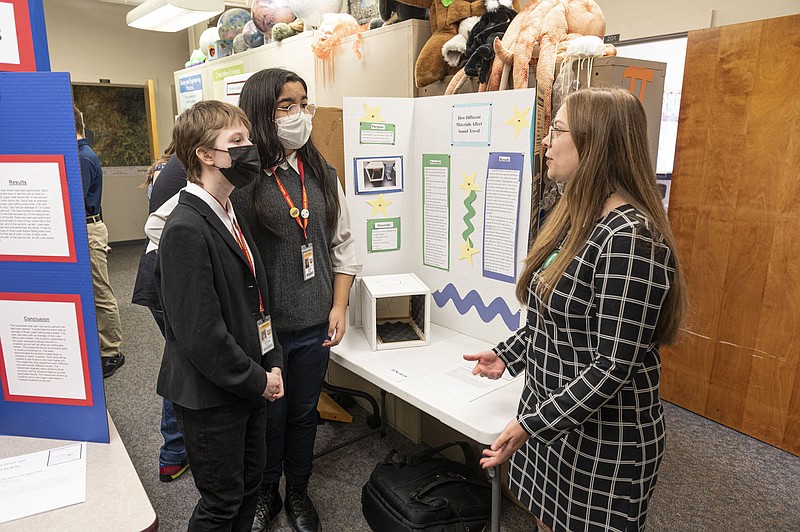 Samantha Middleton, from right, a Noyce Fellow at the University of Arkansas studying teacher education talk with Elijah Smith and Liah Tover from Lakeside Junior High in Springdale about their science fair entry. Middleton mentors the 8th grade science student at their school as part of her fellowship.
(NWA Democrat-Gazette/Spencer Tirey)