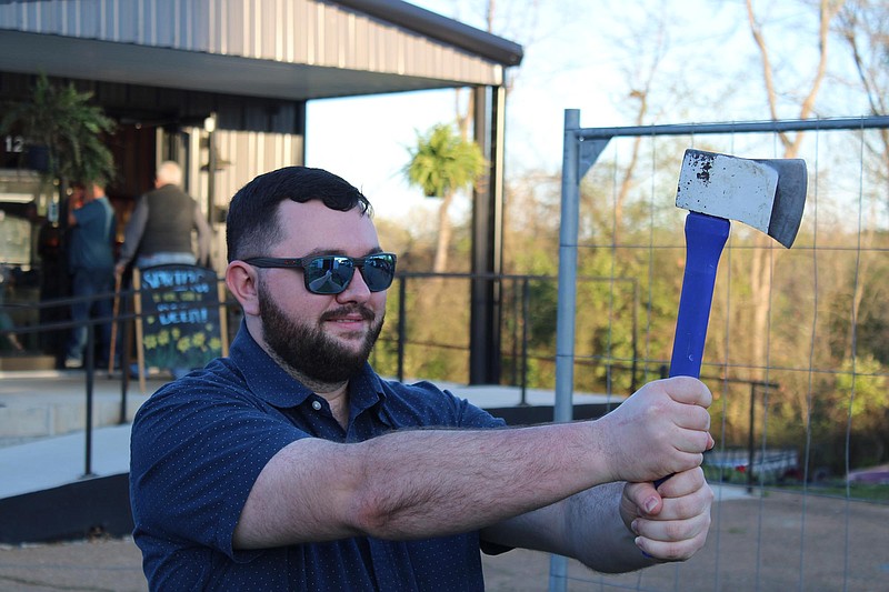 Photo by Michael Hanich
A First Friday attendee prepares to throw an ax at Native Dog Brewing at the open air market on Friday April 1, 2022.