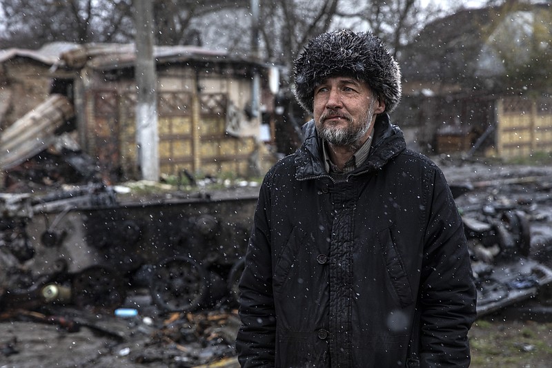 A man is seen near damaged homes and destroyed Russian tanks, armored vehicles and other equipment in Bucha, Ukraine on April 3. MUST CREDIT: Photo by Heidi Levine for The Washington Post.