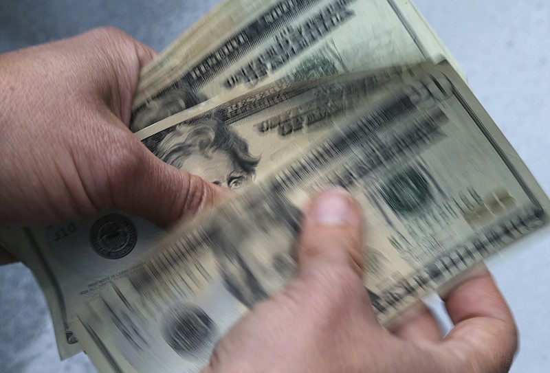 In this June 15, 2018, file photo, twenty dollar bills are counted in North Andover, Mass.  You’ve mastered the basics of money management — the bank accounts, the emergency fund, the 401(k) you contribute enough to so you get your employer match. Maybe you’ve even dabbled in investing, but otherwise you’ve been on autopilot for a few years.   (AP Photo/Elise Amendola, File)