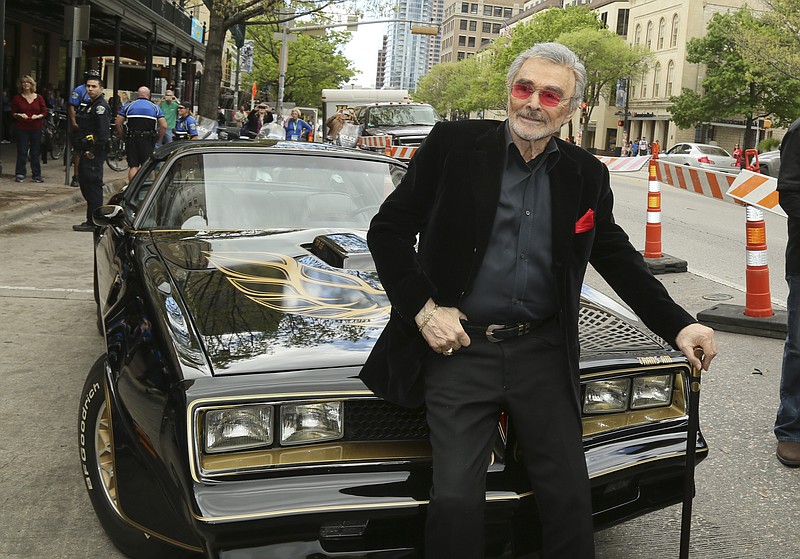 In this March 12, 2016, file photo, Burt Reynolds sits on a 1977 Pontiac Trans Am at the world premiere of "The Bandit" at the Paramount Theatre during the South by Southwest Film Festival in Austin, Texas. (Photo by Jack Plunkett/Invision/AP)