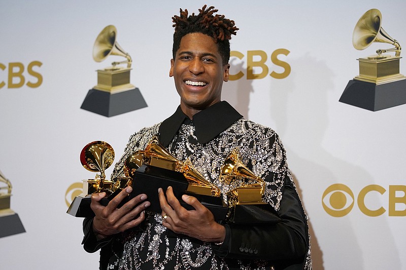 Jon Batiste, winner of the awards for best American roots performance for “Cry,” best American roots song for “Cry,” best music video for “Freedom,” best score soundtrack for visual media for “Soul,” and album of the year for “We Are,” poses with his trophy haul backstage at the Grammy Awards on April 3. (AP Photo/John Locher)