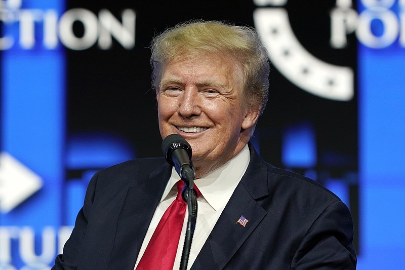 FILE - In this July 24, 2021, file photo former President Donald Trump smiles as he pauses while speaking to supporters at a Turning Point Action gathering in Phoenix. Stock in a company planning to buy Trump's new social media business plunged Monday, April 4, 2022 on a news report that two key staff members left and a regulatory filing that it will miss a key deadline to file its annual financial statements. (AP Photo/Ross D. Franklin, File)