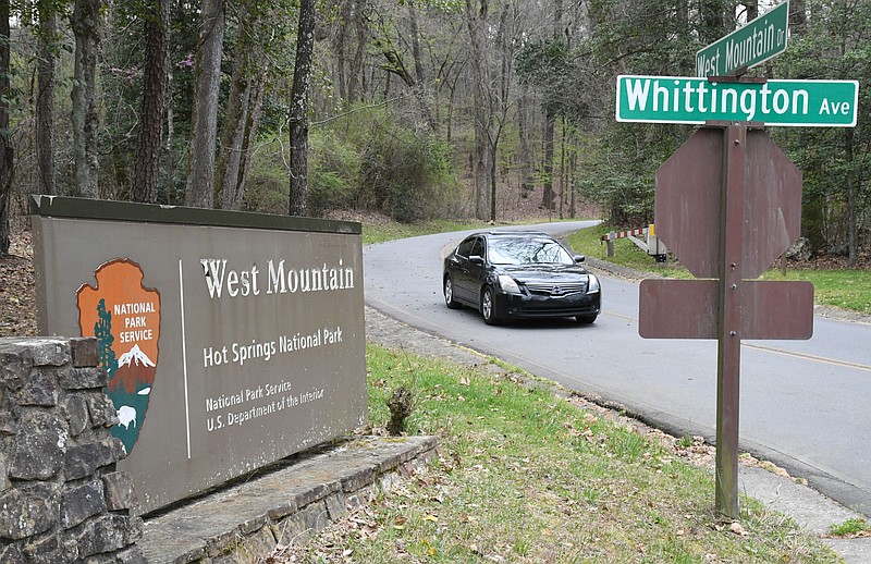 A car passes by Friday on West Mountain Drive, which recently reopened after being closed for nearly two months due to construction. - Photo by Tanner Newton of The Sentinel-Record