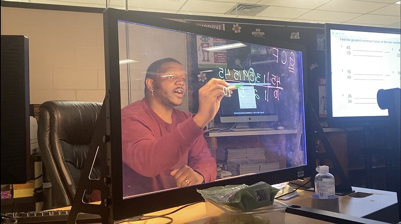 Fifth-grade teacher Darren Baker uses the eGlass board during a lesson Tuesday, April 5, 2022, at Harmony Leadership Academy in Texarkana, Arkansas. (Staff photo by Andrew Bell)