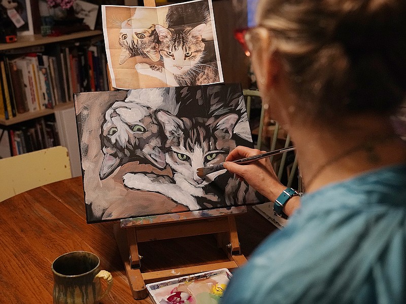 Artist Kat Corrigan works on one of her paintings for her 30 cats in 30 days project from her home Tuesday, March 15, 2022, in Minneapolis. (David Joles/Minneapolis Star Tribune/TNS)