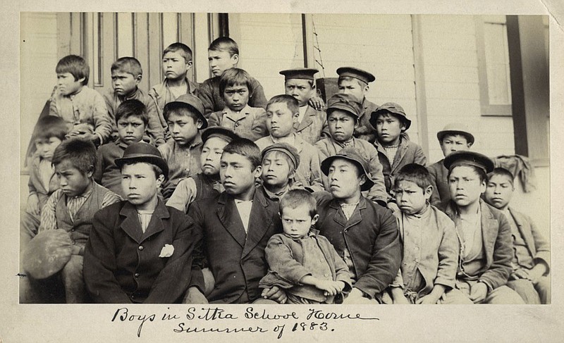 FILE - This photo made available by the Presbyterian Historical Society, Philadelphia shows students at a Presbyterian boarding school in Sitka, Alaska in the summer of 1883. U.S. Catholic and Protestant denominations operated more than 150 boarding schools between the 19th and 20th centuries. Native American and Alaskan Native children were regularly severed from their tribal families, customs, language and religion and brought to the schools in a push to assimilate and Christianize them. (Presbyterian Historical Society, Philadelphia via AP, File)