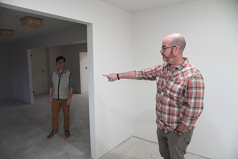 Matt Bell, right, owner and CEO of Origami Sake, and Ben Bell, left, company vice president, give a tour of the facility they are renovating for the brewery. - Photo by Tanner Newton of The Sentinel-Record