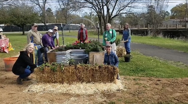 Members of the Miller County Red Dirt Master Gardeners are shown with their straw gardening beds near the Gateway Farmer's Market. Photo by Clyde Davis