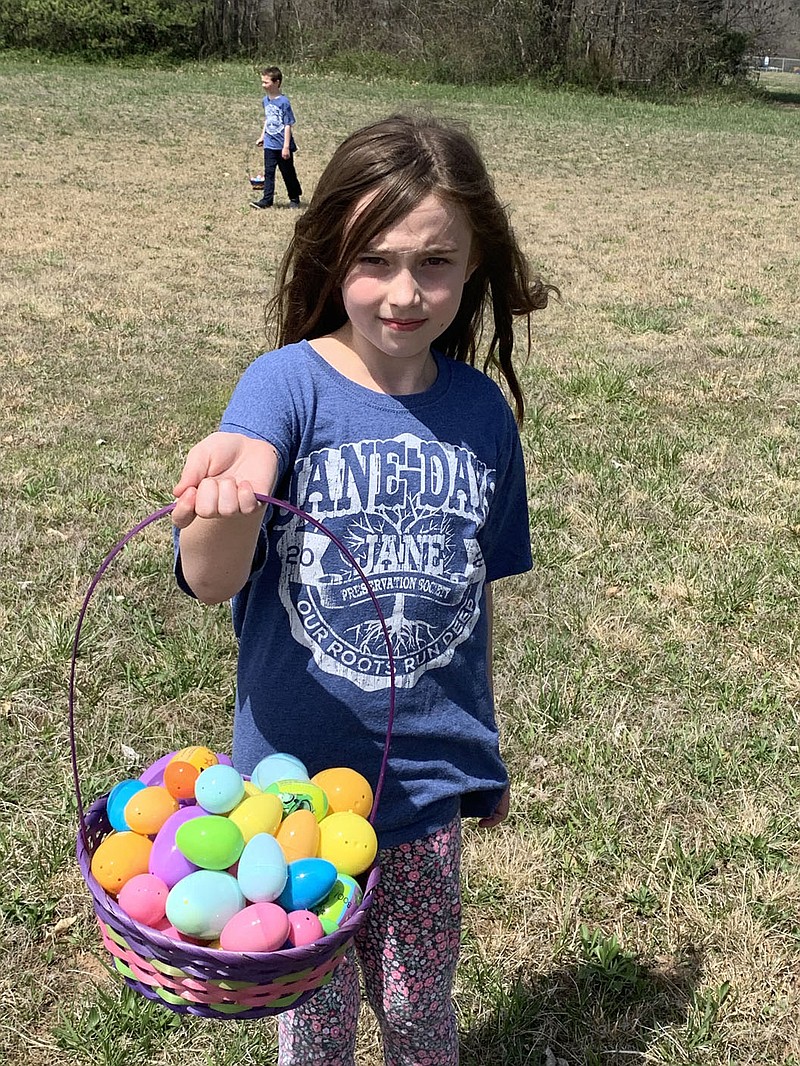 Sally Carroll/Special to the McDonald County Press Holly Coberley, 8, shows off the big basket of Easter eggs she gathered Sunday afternoon at the Jane Easter Egg Hunt.