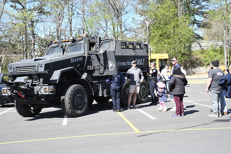 Families line up to see the Hot Springs Police Department SWAT team’s MRAP vehicle Saturday at Touch-A-Truck, a fundraiser at Lakeside for the Primary and Intermediate schools. - Photo by Tanner Newton of The Sentinel-Record