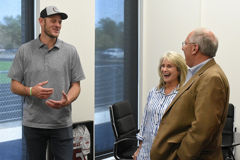 White Hall High School football Coach Ryan Mallett talks with district administrative assistant Beverly Beck and her husband David during an open house of the multipurpose facility Sunday, April 10, 2022. (Pine Bluff Commercial/I.C. Murrell)