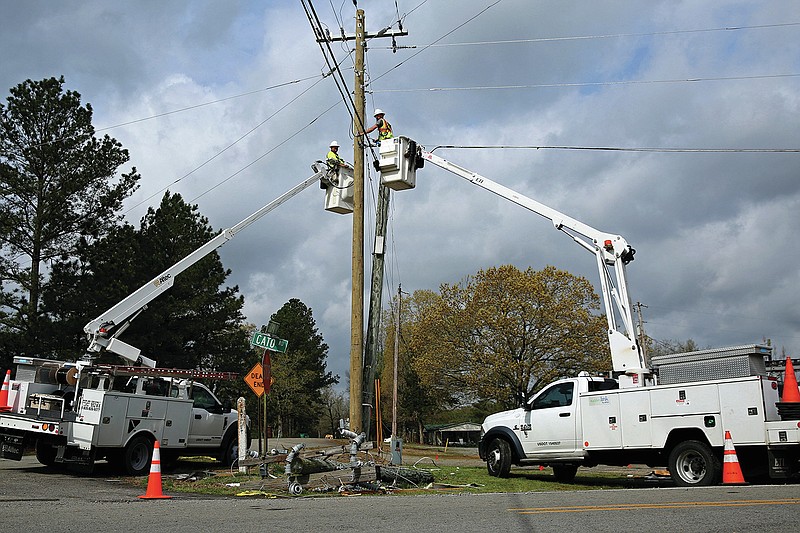 Utility crews work on power lines near Cato on Tuesday, April 12, 2022 after a severe storm system moved through the area Monday night. (Arkansas Democrat-Gazette/Colin Murphey)