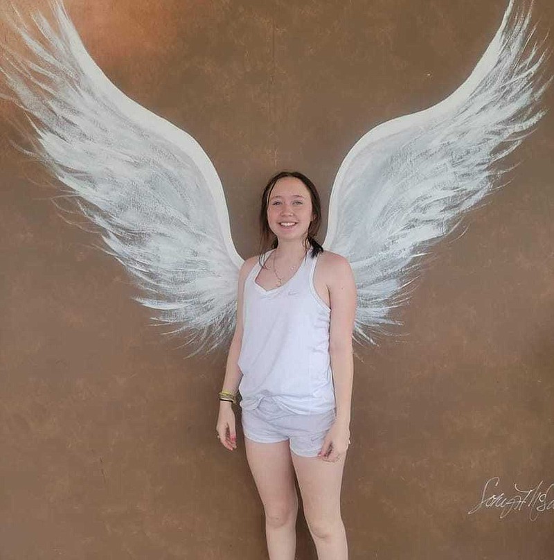 Lak stands in front of an angel wing mural before the accident. (Photo contributed by Elaina Jones)