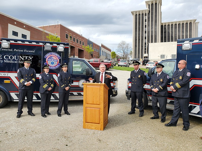 News Tribune/Jeff Haldiman
Cole County Presiding Commissioner Sam Bushman, flanked by Cole County EMS command staff, gives brief remarks at a ceremony Thursday afternoon, marking the approval of grant funding for a new EMS base to be built at the corner of Adams and East McCarty Streets.