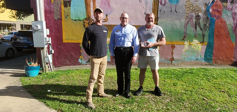 Photo by Bradly Gill
Travis Daniel, left and Mike Tidwell, right, flank Greg Phillip, Director of Main Street Arkansas as the two Camden residents received an honorable mention award for Outstanding Downtown Impact in the revitalization of downtown Camden.