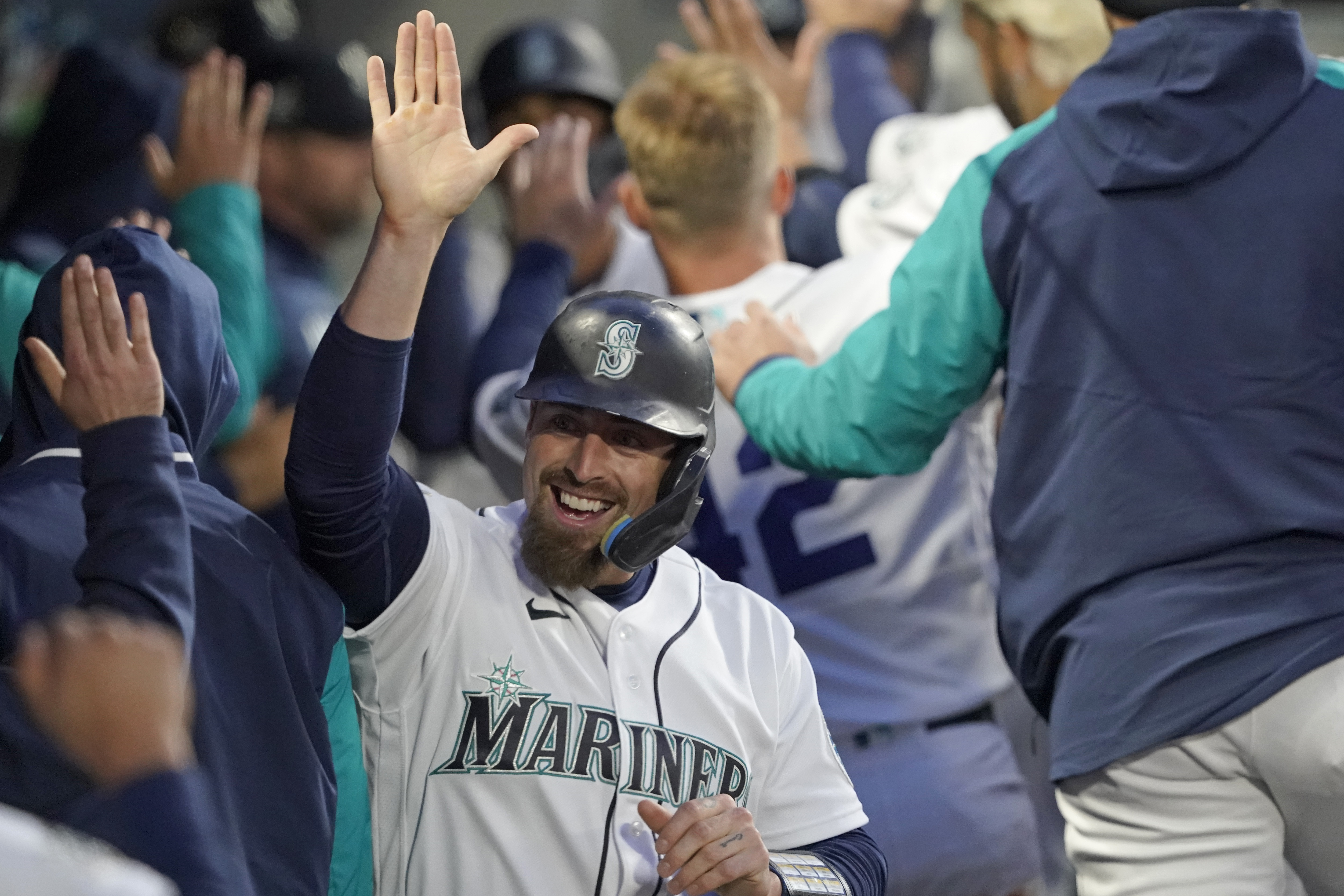 Seattle Mariners fans sit near a sign, based on the popular Wordle