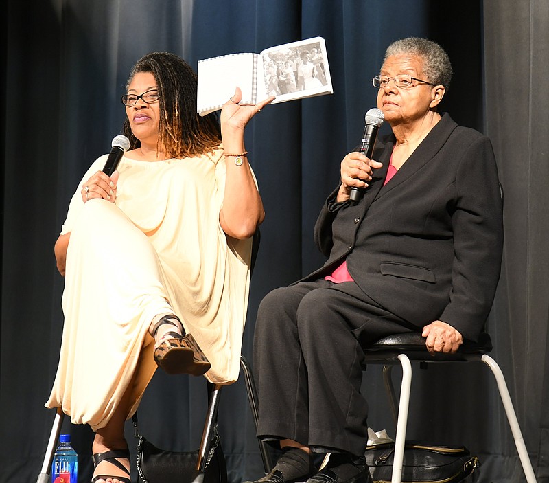 Elizabeth Eckford, right, a member of the Little Rock Nine, speaks about her first day at high school, while Eurydice Stanley, co-author of Eckford’s book “The Worst First Day: Bullied While Desegregating Central,” holds the book open to a famous photo of Eckford. The two women spoke April 9 during the closing event of the Hot Springs Book Festival at Main Street Visual and Performing Arts Magnet School. - Photo by Tanner Newton of The Sentinel-Record